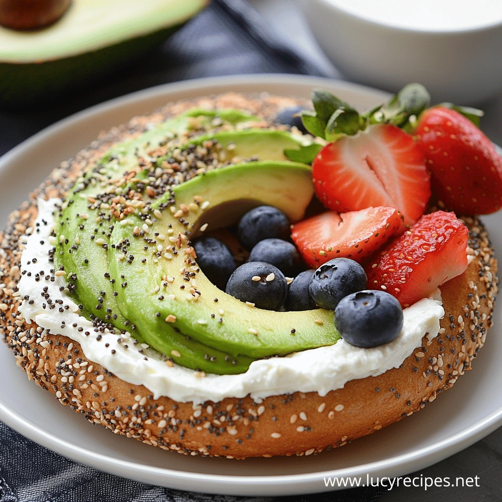 A bagel topped with cream cheese, fresh avocado slices, blueberries, and strawberries, sprinkled with seeds. A nutritious and delicious breakfast option. How many calories are in one bagel with cream cheese?